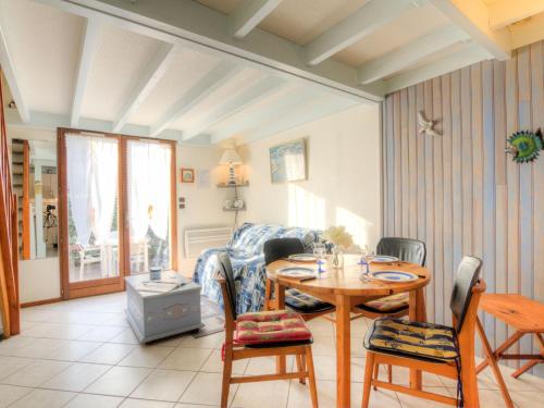 a living room with a table and chairs at Holiday Home Jardins de l'Océan-3 by Interhome in Saint-Georges-de-Didonne