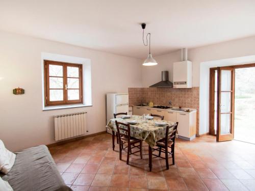a kitchen and dining room with a table and chairs at Apartment I Tigli by Interhome in Rufina