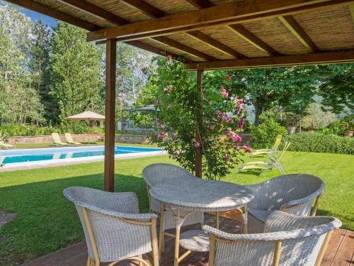 a patio with a table and chairs and a pool at Apartment I Tigli by Interhome in Rufina