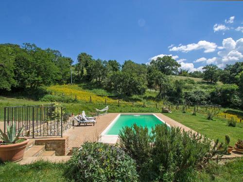 a swimming pool in a yard with a fence at Holiday Home Casalini by Interhome in Montorgiali