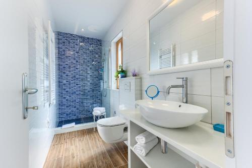 een witte badkamer met een wastafel en een toilet bij St.Lucija in Split