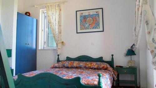 a bedroom with a bed and a picture on the wall at Heliatoras Studios in Loutrópolis Thermís