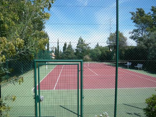 a tennis court with a gate on a tennis court at Holiday Home Bonporteau-3 by Interhome in Cavalaire-sur-Mer