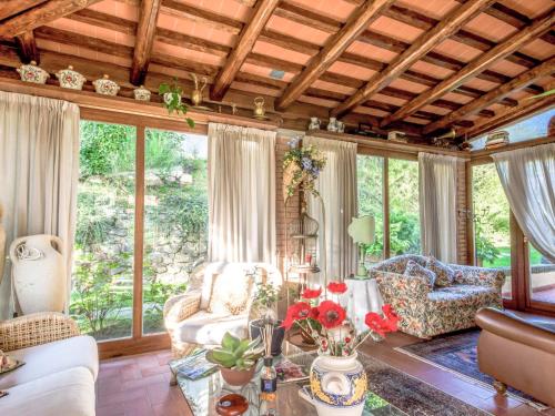 a living room filled with furniture and windows at Villa Villa Campo del Mulino by Interhome in Piteccio