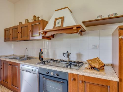 a kitchen with a stove top oven next to a sink at Villa Beboli by Interhome in Lamporecchio