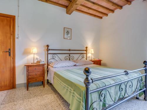 a bedroom with a bed and a table with lamps at Villa Beboli by Interhome in Lamporecchio