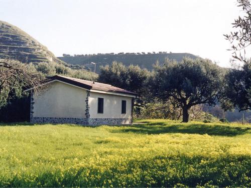 a small white house in a field of grass at Holiday Home Lulablu by Interhome in Drapia