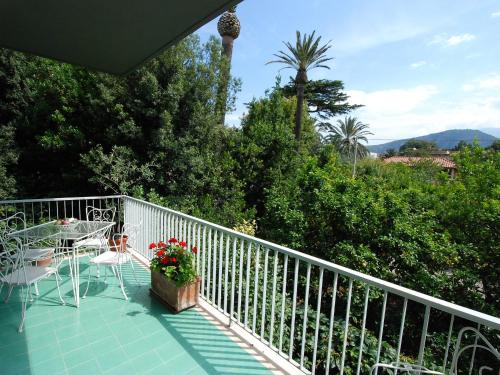 a balcony with a table and chairs and trees at Locazione Turistica Riviera Massa in Sorrento