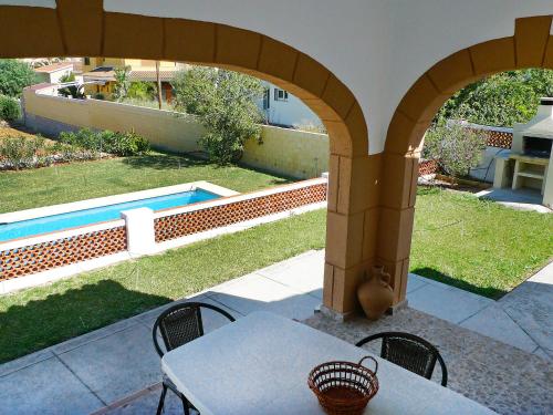 a patio with a table and chairs and a pool at Holiday Home Pia by Interhome in Denia