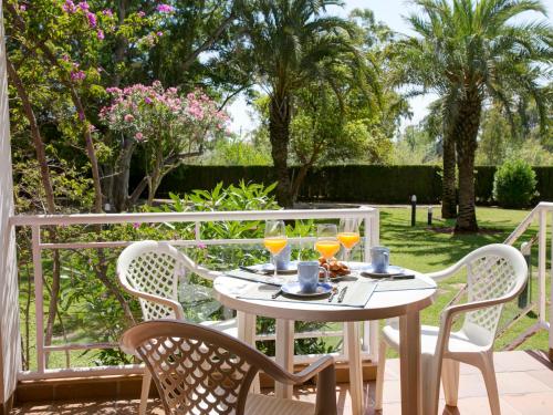a table with two glasses of orange juice on a patio at Apartment Keops by Interhome in Casas Devesa