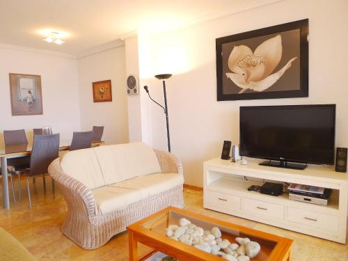 a living room with a couch and a tv at Apartment Altea Dorada by Interhome in Altea la Vieja