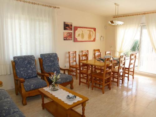 a living room with a dining room table and chairs at Holiday Home Mestral by Interhome in Alcanar