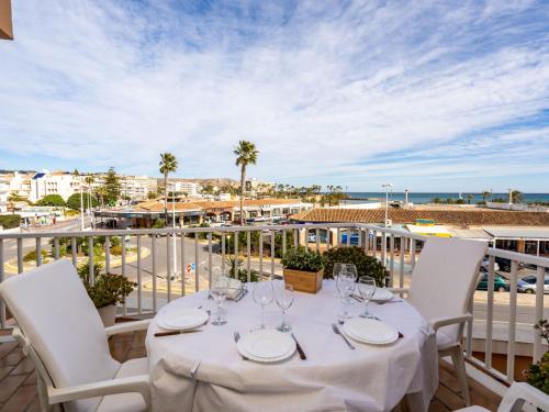 a table on a balcony with a view of the ocean at Apartment Sorolla-1 by Interhome in Jávea