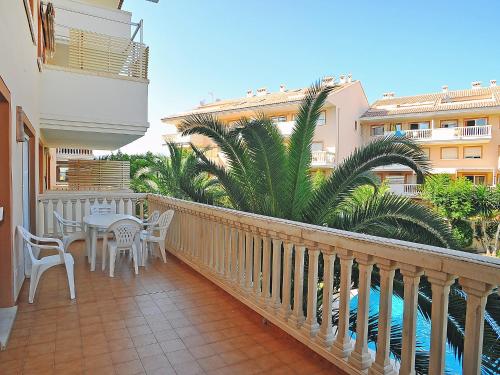 a balcony with a table and chairs and a pool at Apartment Nou Fontana-4 by Interhome in Jávea