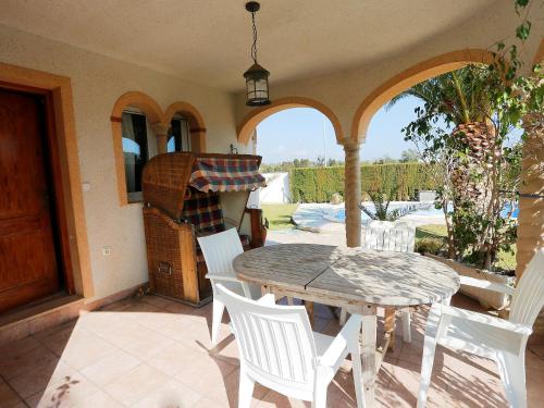 a patio with a table and chairs and a grill at Holiday Home Dirk by Interhome in L'Ampolla