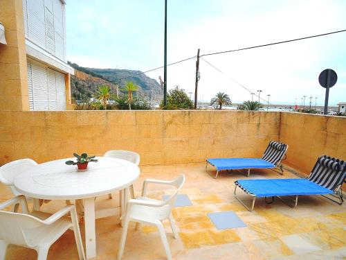 a patio with a table and chairs on a balcony at Apartment Atarazanas by Interhome in Aduanas