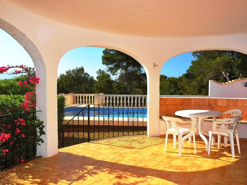 a patio with a table and chairs and a pool at Holiday Home Balcon al Mar by Interhome in Balcon del Mar