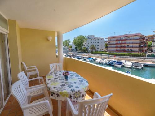 a balcony with a table and chairs and a view of a harbor at Apartment Girasol by Interhome in Jávea