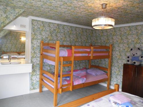 a bedroom with two bunk beds and a sink at Apartment Poperinge by Interhome in Poperinge