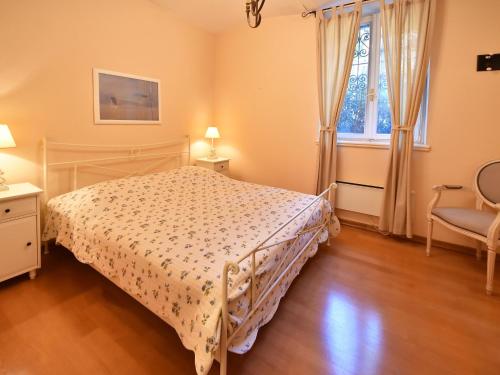 a bedroom with a bed and a window at Apartment Deni-1 by Interhome in Volosko