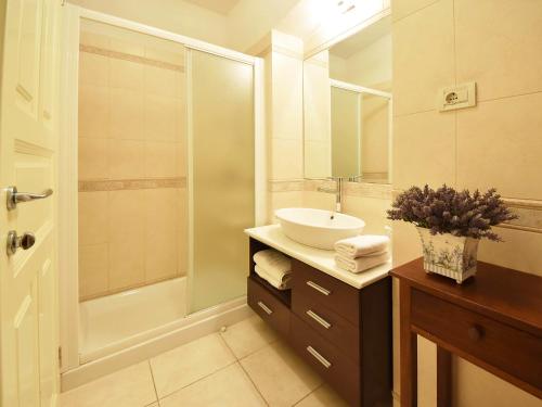 a bathroom with a sink and a shower at Apartment Deni-1 by Interhome in Volosko
