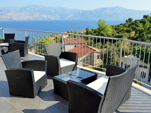a balcony with chairs and a view of the water at Apartment Molo Lozna-2 by Interhome in Postira