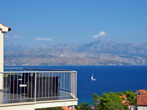 a sailboat in the water on a balcony of a building at Apartment Molo Lozna-2 by Interhome in Postira