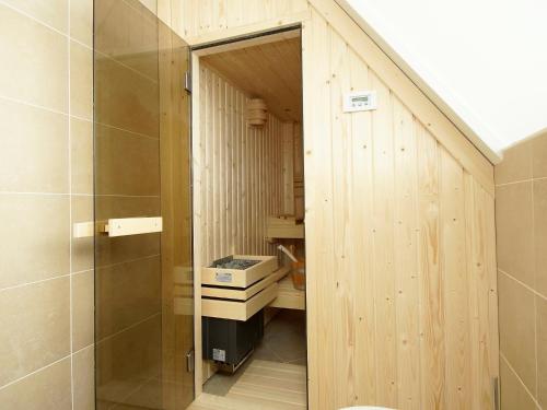 a bathroom with a walk in shower next to a toilet at Holiday Home Ganuenta-1 by Interhome in Colijnsplaat