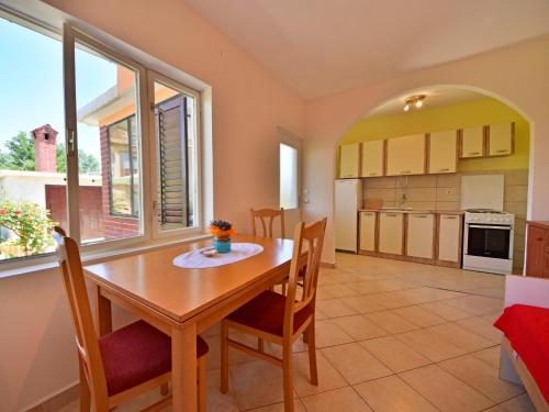a kitchen and dining room with a table and chairs at Holiday Home Franjo-2 by Interhome in Ika