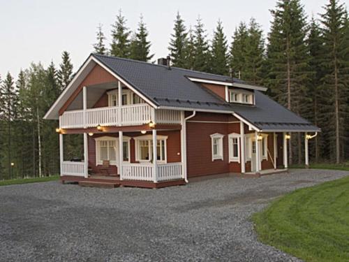 a large house with a gambrel roof at Holiday Home Arhippa by Interhome in Kurkimaki