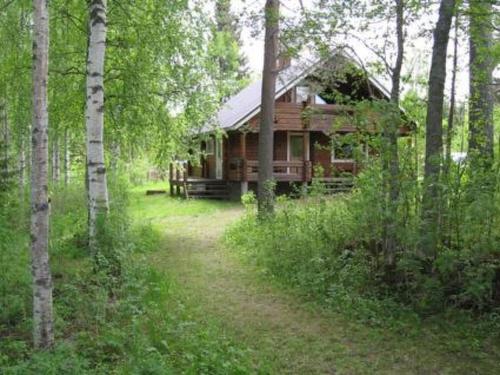 a cabin in the middle of a forest with trees at Holiday Home Pellervo by Interhome in Kurkimaki