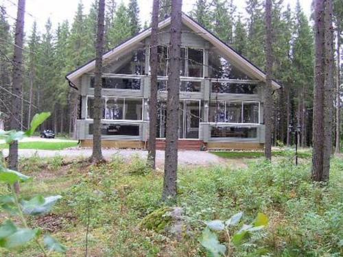 a house in the middle of a forest with trees at Holiday Home Kärkelä by Interhome in Sulkava