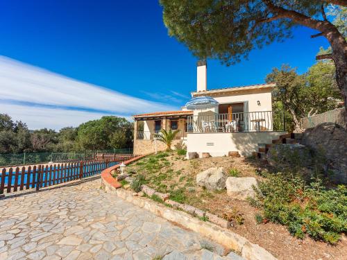 a house with a fence in front of it at Holiday Home Sansu by Interhome in Calonge