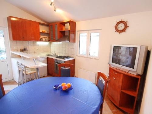 a kitchen with a table with a bowl of fruit on it at Holiday Home Ratimir by Interhome in Rogač