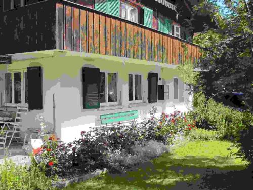 a painting of a house with flowers in the yard at Apartment Helene by Interhome in Adelboden