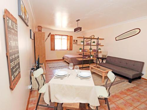 a living room with a table and a couch at Studio Studio Ericeira by Interhome in Ericeira