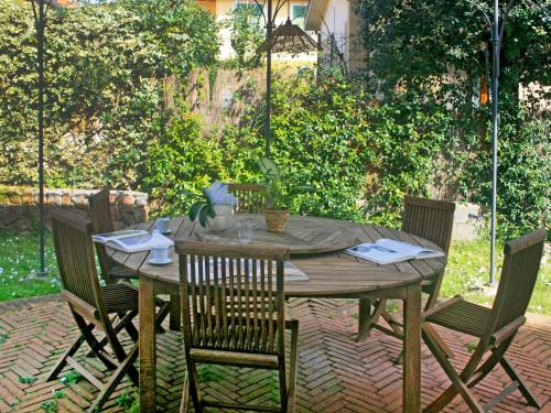 Une table et des chaises en bois sont disponibles sur la terrasse. dans l'établissement Villa Marzia by Interhome, à Forte dei Marmi
