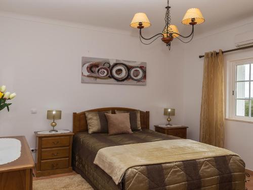 a bedroom with a bed with speakers on the wall at Villa Das Amendoeiras by Interhome in Estevais