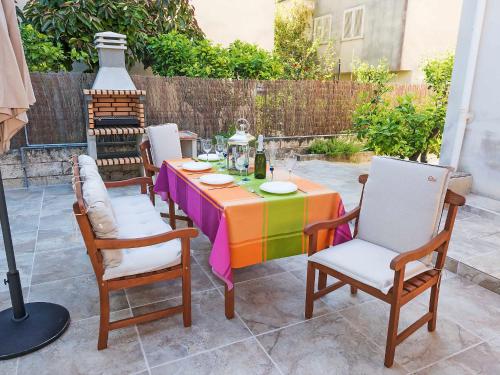 a table with a colorful table cloth on a patio at Holiday Home Can Roses by Interhome in Playa de Muro