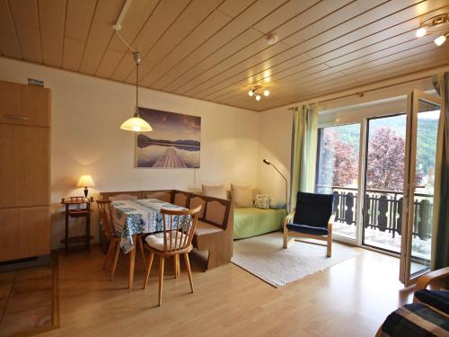 a kitchen and living room with a table and chairs at Apartment Annemarie by Interhome in Glanz