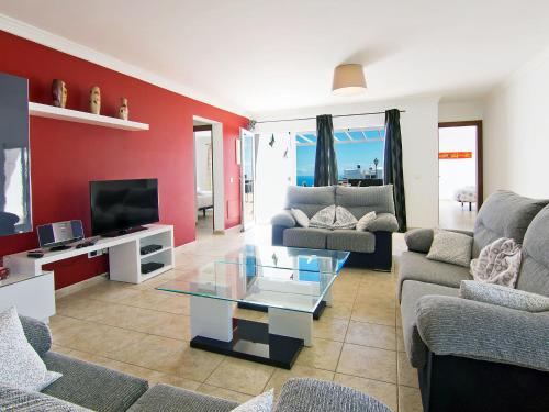 a living room with couches and a tv at Holiday Home Pelzer by Interhome in Conil