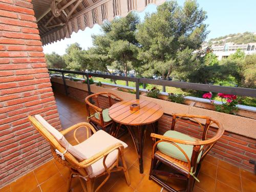 a patio with a table and chairs on a balcony at Apartment Rambla de Tossa by Interhome in Tossa de Mar