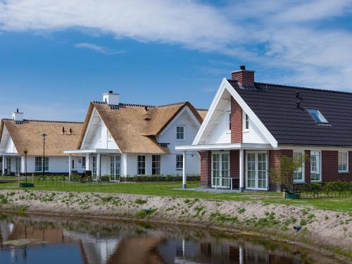 a row of houses next to a body of water at Holiday Home Alk 8-1 by Interhome in Noordwijkerhout
