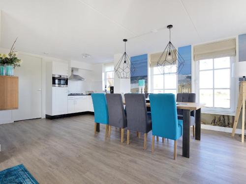 a kitchen and dining room with a table and chairs at Holiday Home Tapuit 8-2 by Interhome in Noordwijk