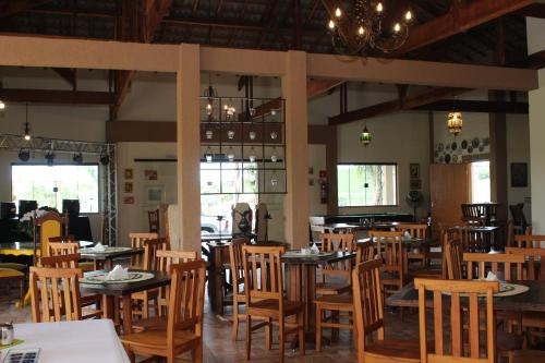 a dining room with wooden tables and chairs at Pousada Sítio Pedras de Minas in Monte Sião