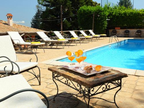 a table with glasses on it next to a swimming pool at Villa Villa Mina by Interhome in Monte Compatri