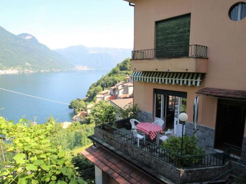 a building with a balcony with a view of a lake at Apartment Sabrina by Interhome in Nesso
