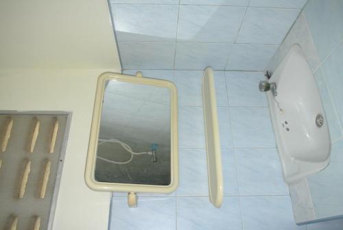 a mirror on a wall in a bathroom at Suksabai Resort in Haad Rin