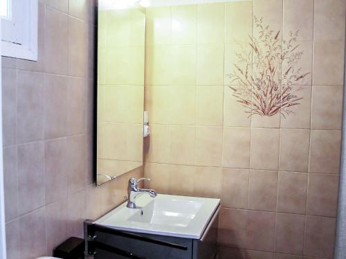 a bathroom with a sink and a mirror at Holiday Home Remember by Interhome in Mimizan-Plage