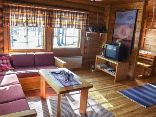 een woonkamer met een bank en een tv bij Holiday Home Kujalan lomat 2 by Interhome in Nissi